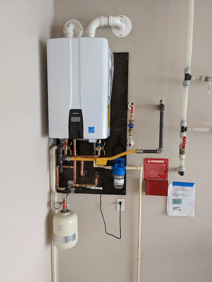 Professional plumber installing copper piping in a Stafford home